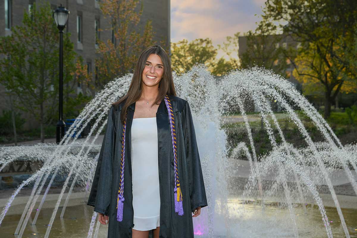 Student infront of fountain