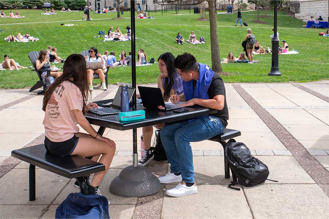 Students using technology on Quad