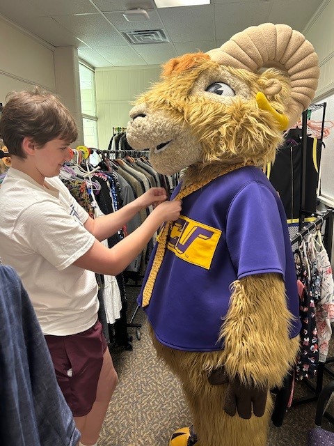 Photo of Rammy putting a tie on