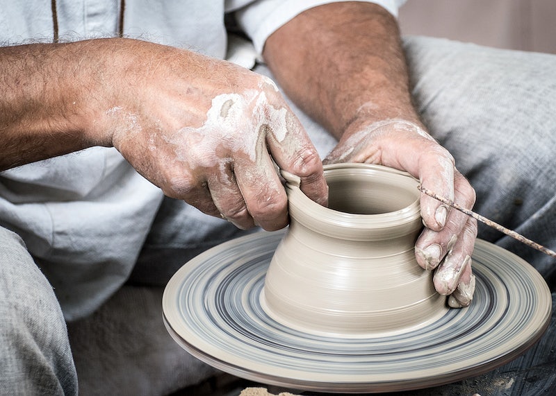 person using potter's wheel