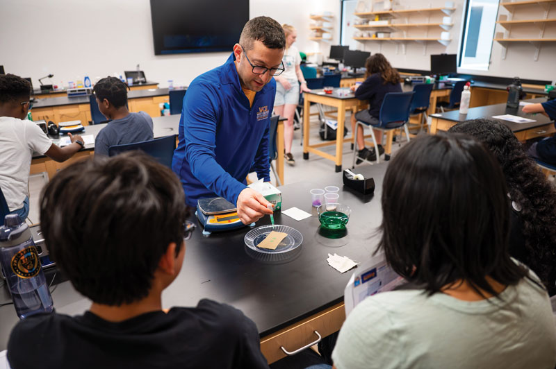 Dr. Brandon Mitchell, the professor of physics and engineering who helped establish and currently leads the University’s Center for STEM Inclusion, works with high school students in a recent workshop held on campus to introduce the youth to careers in science, technology, engineering, and mathematics.