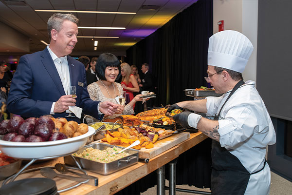 Chef serving food in dining hall