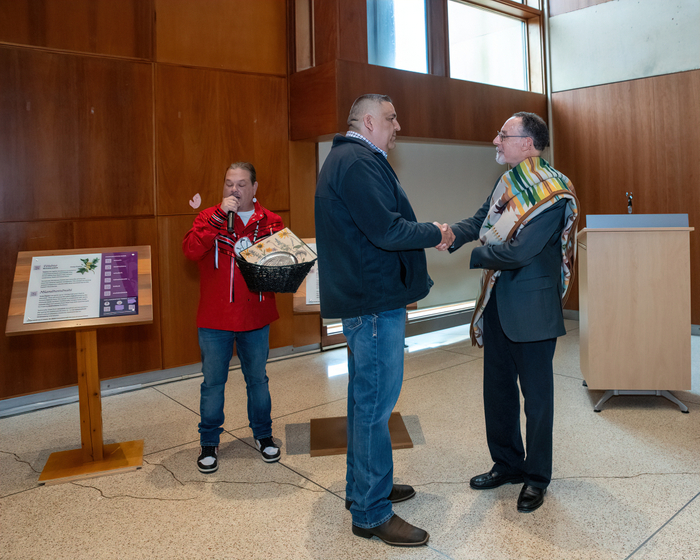 Representatives of the Delaware Tribe of Indians, Mr. Jeremy Johnson (left) and Chief KillsCrow (center) exchange gifts with Christopher Fiorentino