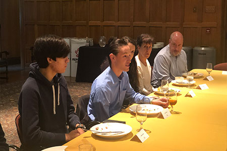 Young  men sitting at table conversing