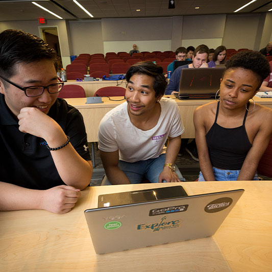 3 Students working on Laptops