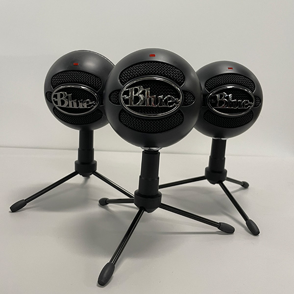 A photo of three black "Snowball" microphones from the company, Blue.