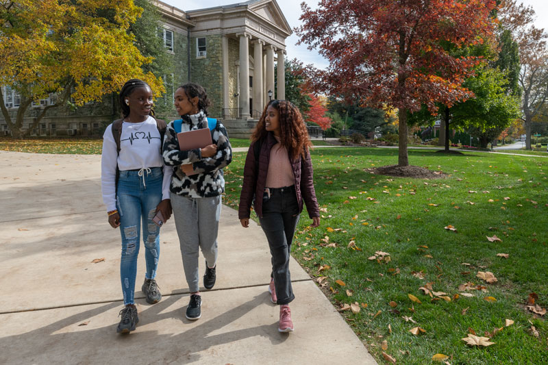 Group of women/students smiling and walking